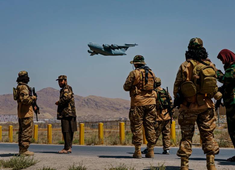 En la foto 1 integrantes del grupo talibán ven el despegue de aviones de EE.UU. En la foto 2 el aeropuerto de Kabul solitario. FOTO getty