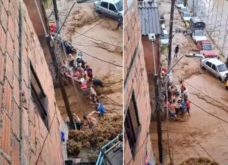 Un grupo de personas rescató a un hombre de la corriente en el barrio Manrique de Medellín. FOTOS: Capturas de video 
