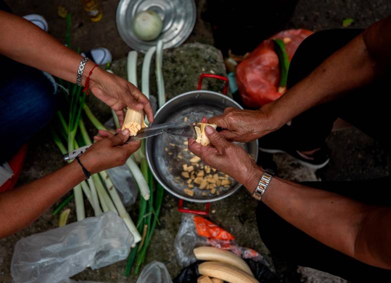 Los afectados que pernoctan en la calle deben preparar los alimentos en la mitad de la calle. Dicen que la ayuda para su alimentación ha provenido principalmente de su propio bolsillo, de la caridad de los vecinos y de algunos funcionarios de Derechos Humanos. FOTO: Camilo Suárez. 