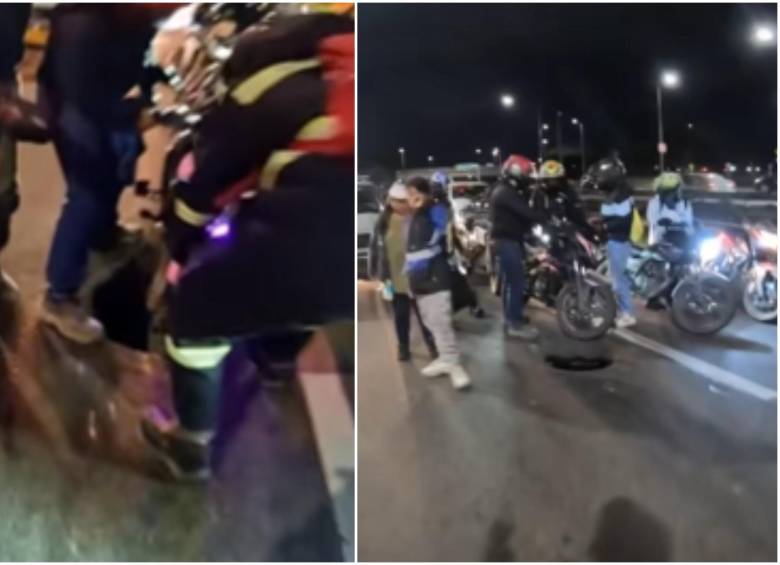 Momento en el que varios ciudadanos se detuvieron a ayudar a la motociclista afectada, para atenderla y ayudarle a sacar la moto del hueco. FOTO: Captura video @santiagolopezp
