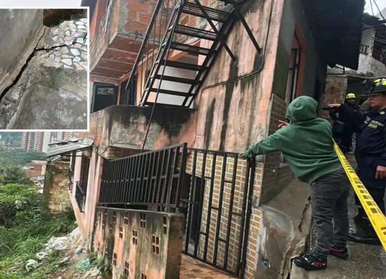 Adelante, una de las grietas que apareció en una de las viviendas afectadas. Atrás, el cierre de las edificaciones por parte de las autoridades. FOTO: Cortesía