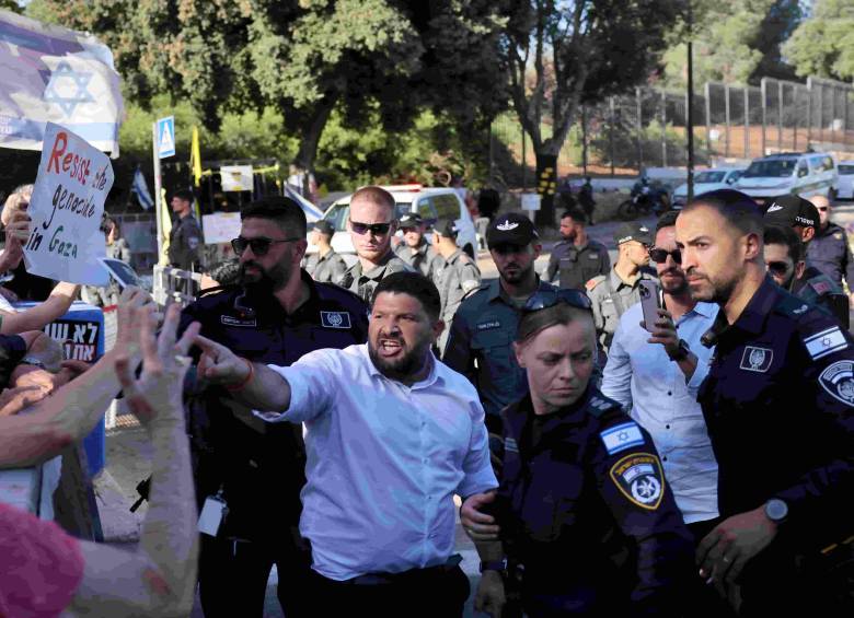 El miembro del parlamento israelí Almog Cohen (C) discute con activistas que se manifiestan frente al Parlamento israelí. FOTO: AFP