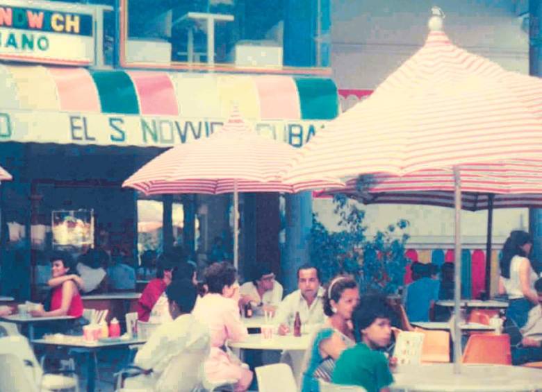 El negocio inició en la Avenida Sexta de Cali en 1979. Los cofundadores, Pablo Gómez y Mario Maya, posan abajo con la gerente, Pilar Amorocho. FOTO CORTESÍA
