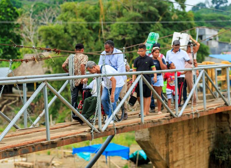 Sobre el puente se vive otra dinámica, un grupo de jóvenes se encarga del cobro por el cruce peatonal improvisado. FOTO Camilo Suárez.