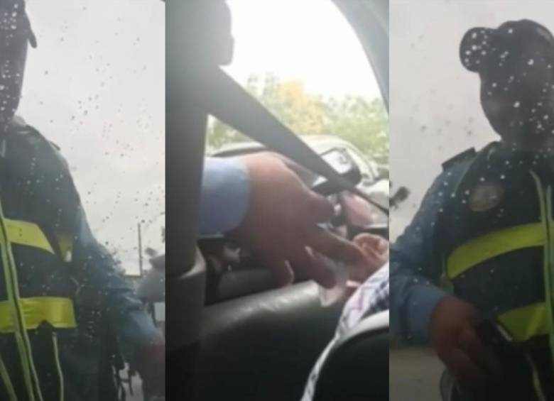 El agente de transito haciendo la ‘transacción’ con la conductora infractora. FOTO: Pantallazos video @leidysriveromartinez
