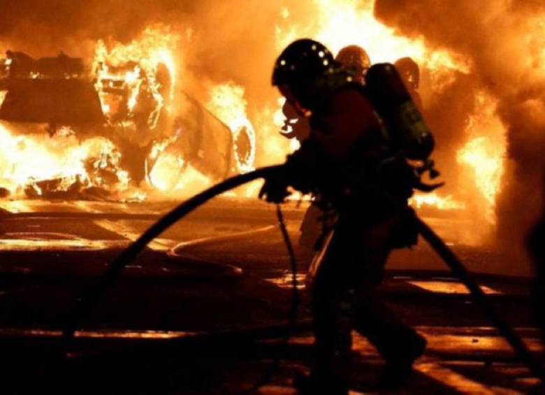 Bomberos atendiendo los incendios de los disturbios en las calles. FOTO: Twitter @NeuronaSV