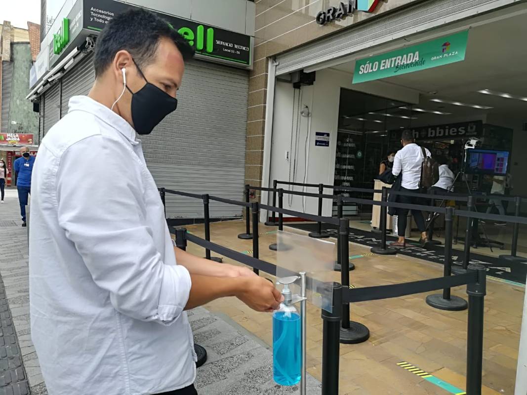 Línea de espera y antibacterial a la entrada de Gran Plaza, en el centro de la ciudad. FOTO MANUEL SALDARRIAGA