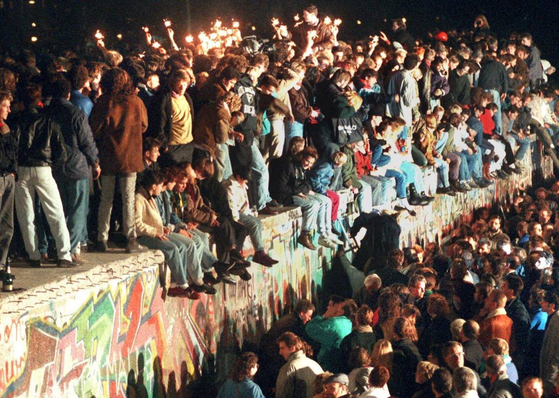 Jóvenes berlineses orientales celebran en lo alto del muro de Berlín. Foto de archivo tomada el 11 de noviembre de 1989. FOTO AFP