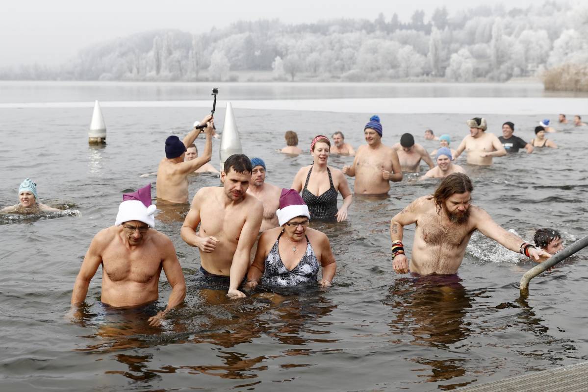 Los suizos acostumbran a nadar en el agua helada del lago Moossee el 31 de diciembre. La temperatura ambiente es de -3 grados centígrados. FOTO AP