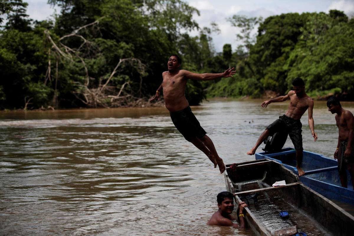 Un migrante de Bangladés se lanza en el río Chucunaque. Los migrantes provienen de países de Asia, África y el Caribe. FOTO: EFE