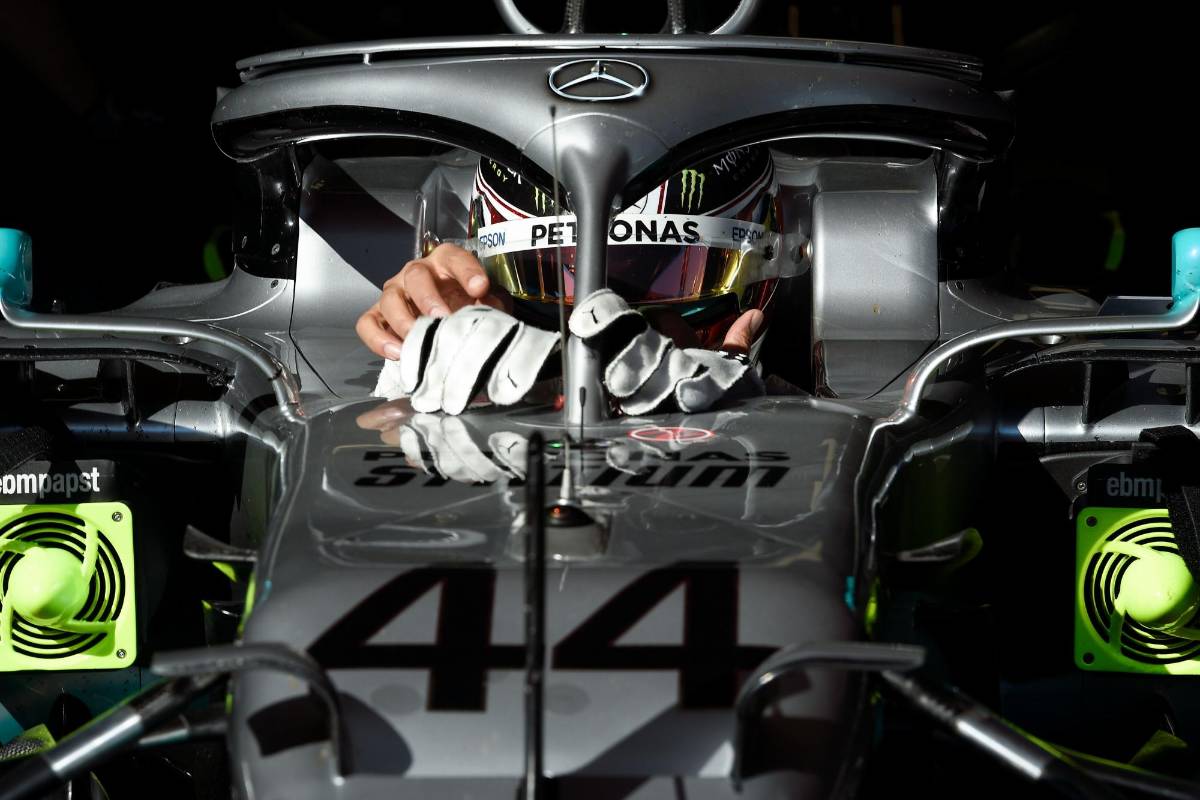 El piloto británico de Mercedes, Lewis Hamilton, se quita los guantes cuando participa en las pruebas para la nueva temporada del Gran Premio de Fórmula Uno en el circuito de Cataluña en Montmeló. Foto: AFP. LLUIS GENE