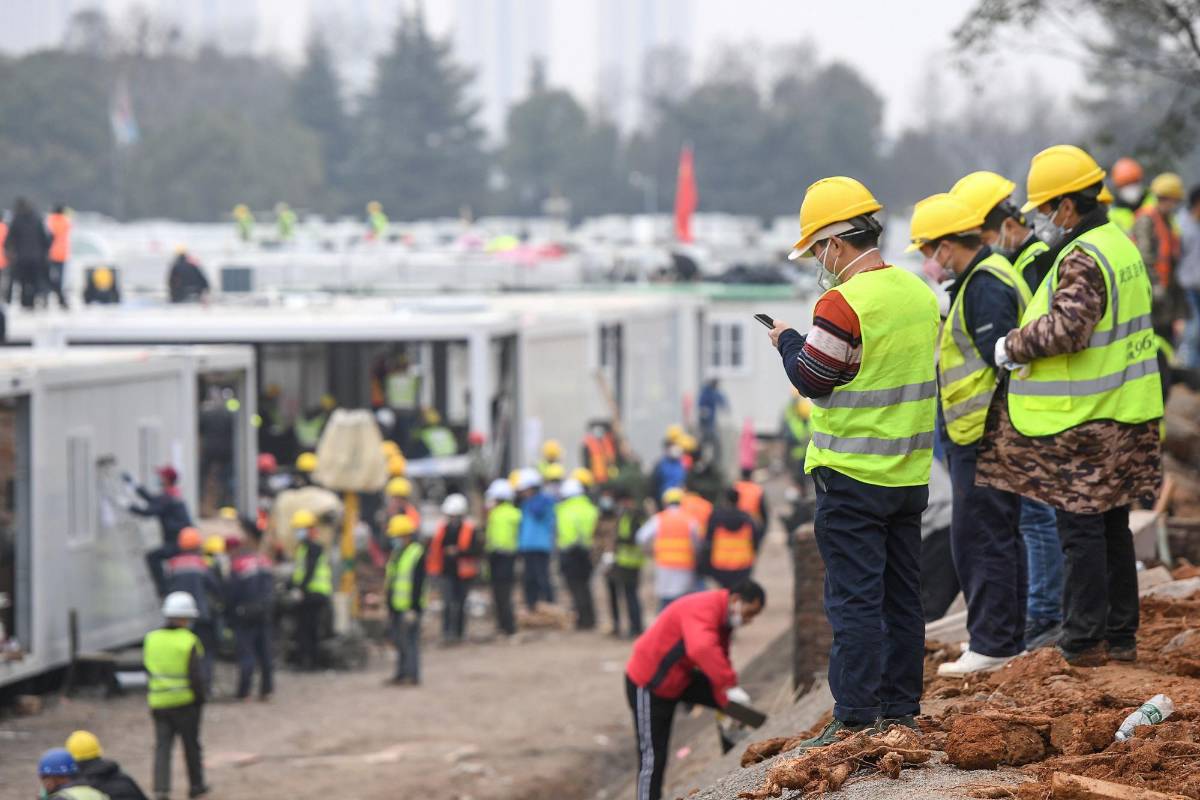 Los trabajadores, afuera del hospital, luego de que se entregó la obra. FOTO AFP