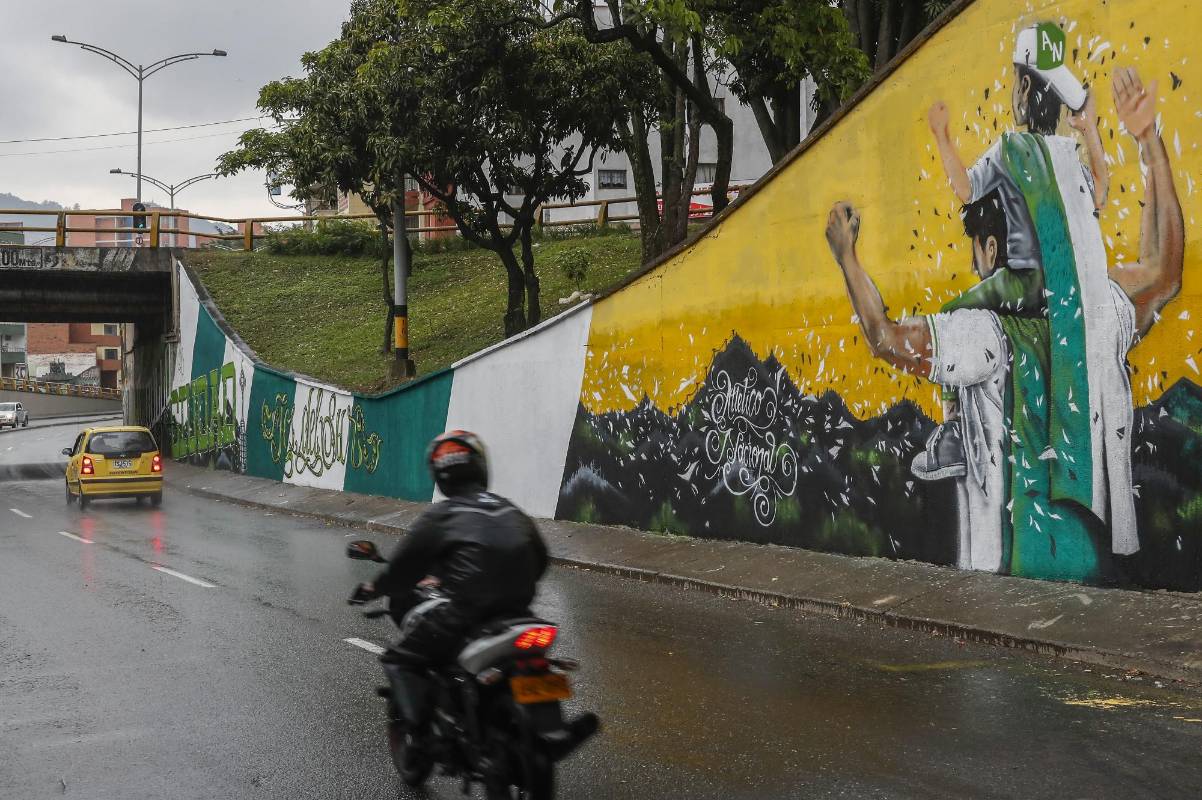 Barristas de Independiente Medellín y Atlético Nacional intervinieron el deprimido de San Juan con la 80, en el barrio La América, y enviaron a la ciudad un mensaje de respeto y convivencia a menos de ocho días de otro clásico paisa. FOTO ROBINSON SÁENZ 