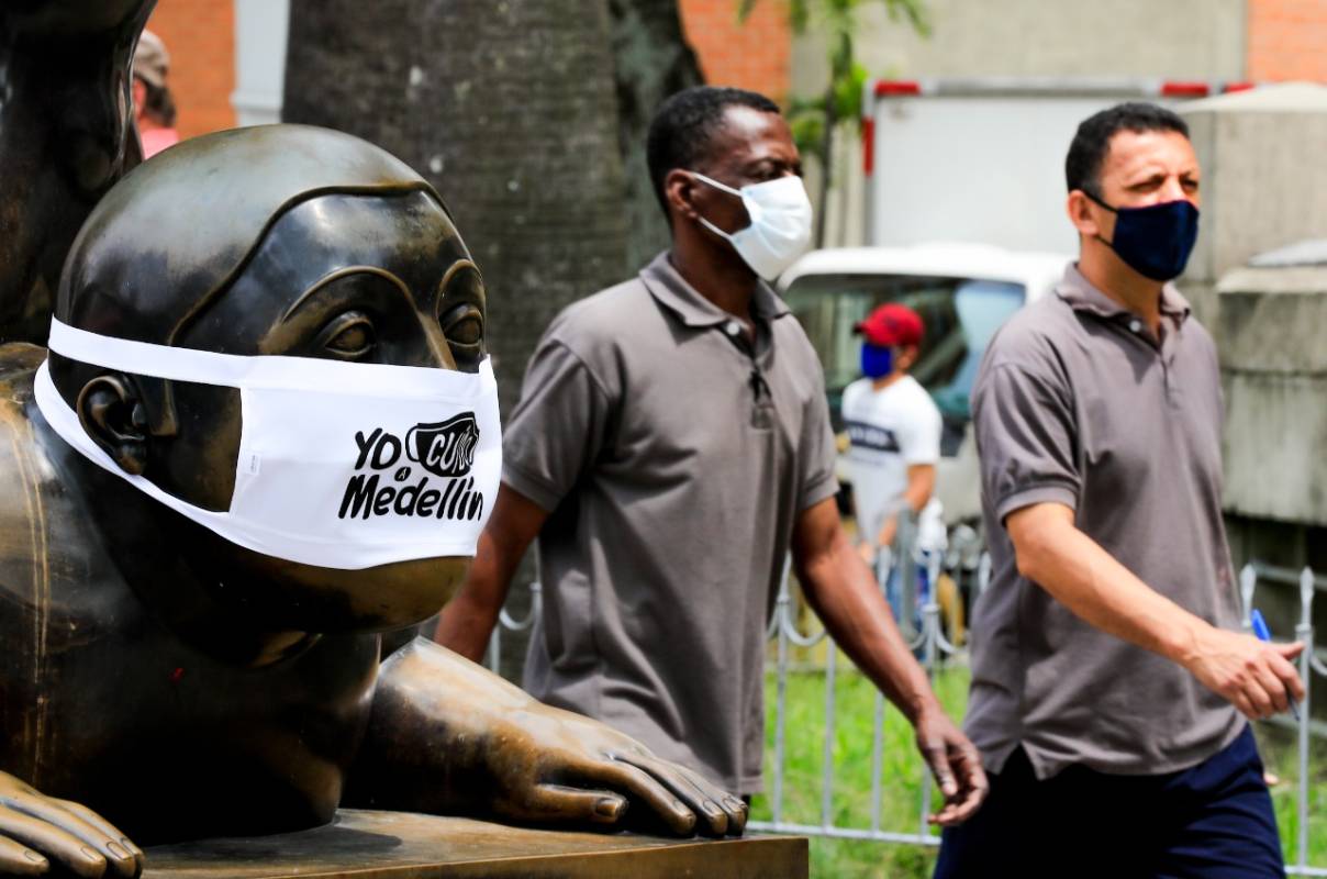 En la Plaza Botero, en inmediaciones del Museo de Antioquia, los rostros de las tradicionales figuras del maestro Fernando Botero fueron cubiertos con tapabocas. FOTO JAIME PÉREZ