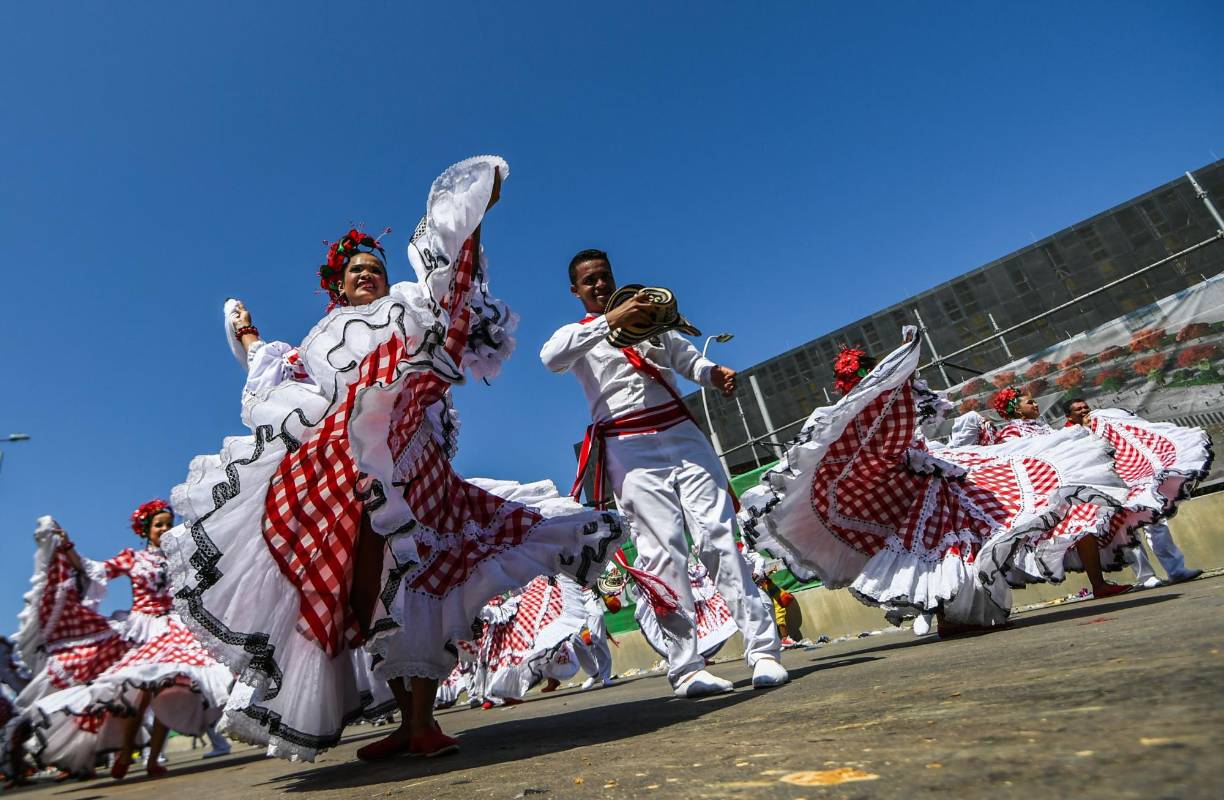 Cómodamente sentados bajo la sombra desde los palcos dispuestos por los organizadores, o de pie al lado de la avenida y bajo el inclemente sol tropical, los asistentes pudieron observar este año la Batalla de Flores en medio de la alegría y el jolgorio. FOTO AFP