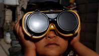 Un niño usa anteojos protectores especiales para observar un eclipse solar parcial en Sanaa, Yemen, 21 de junio de 2020. FOTO EFE