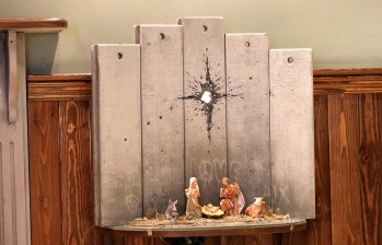 El hotel del artista británico Banksy en la ciudad palestina de Belén acoge estas navidades un singular nacimiento, en el que José, María y el niño Jesús tienen de telón de fondo el imponente muro israelí con un impacto de proyectil con forma de estrella. Foto: EFE
