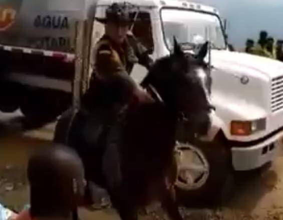 Captura de pantalla del video en el que se ve al carabinero apuntando a la multitud.