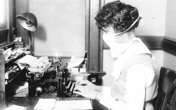 Esta secretaria muestra el tipo de tapabocas, en 1918, que bajaba hasta el cuello. FOTO Getty