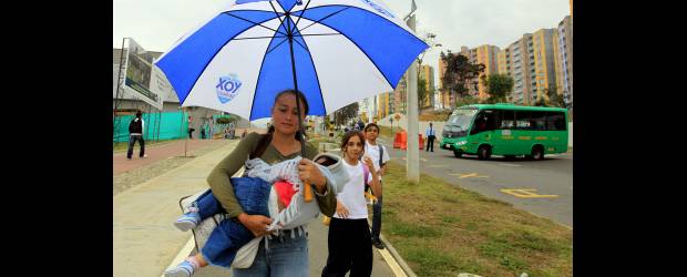 Vecinos, felices con la Villa Suramericana | Donaldo Zuluaga | Julia Gómez camina con su hija frente a la Villa Suramericana, de la que es vecina. Para ella, que deportistas de distintas partes del continente estén en la ciudad le parece una forma de mostrar el cambio de la ciudad.