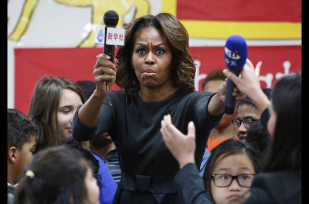 Reuters - Michelle Obama, en su visita a una escuela China en Washington, encontr&#243; micr&#243;fonos bajo su silla. Los micr&#243;fonos pertenec&#237;an a estaciones de televisi&#243;n de dicho pa&#237;s que preparan el cubrimiento del viaje de la primera dama a China.