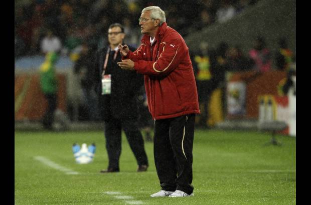 AP - Los técnicos. Marcelo Lippi de Italia con chaqueta roja, y en el fondo Gerardo Martino de Uruguay.