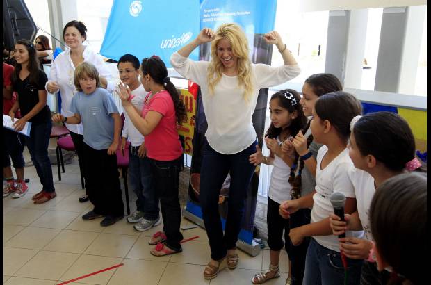 Reuters - Shakira, que acudi&#243; al centro escolar sin la compa&#241;&#237;a de su novio, el jugador del F.C. Barcelona Gerard Piqu&#233;, se mezcl&#243; entre los peque&#241;os, muchos de los cuales luc&#237;an camisetas azulgranas, y no dud&#243; en abrazar y saludar a todos los que pudo, mientras se sentaba entre ellos en primera fila para poder ver la actuaci&#243;n.