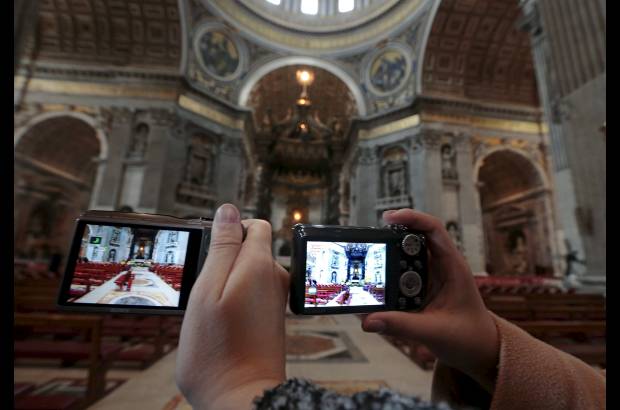 Reuters - Decenas de turistas toman fotos dentro de la Bas&#237;lica de San Pedro.