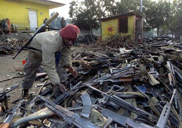 Reuters - Un soldado de Zaire inspecciona montones de armas confiscadas a las tropas del gobierno de Ruanda después de haber huido de la ciudad fronteriza de Gicenyi el 18 de julio de 1994. La masacre supuso el exterminio de entre el 20 y el 40 por ciento de la población de Ruanda, entonces el país más densamente habitado de África con siete millones de personas.
