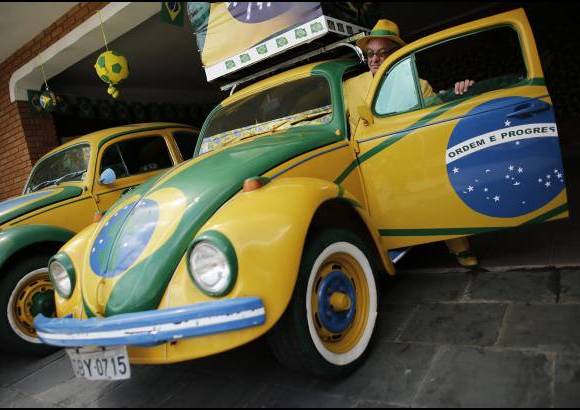 Reuters - Sus dos Volkswagen est&#225;n pintados para llamar la atenci&#243;n y mostrar su bandera.