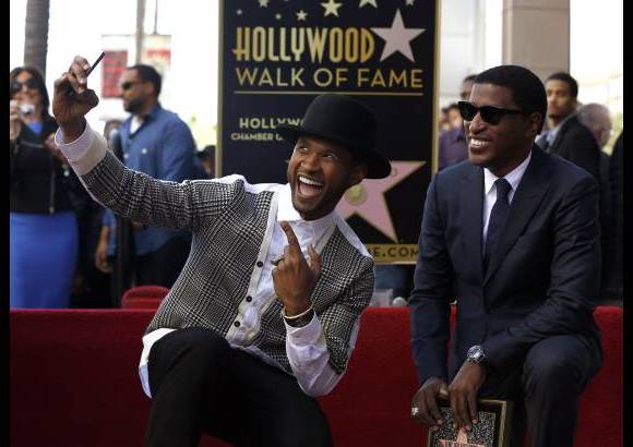 RE - El cantante y compositor Kenneth &quot;Babyface&quot; posa con Usher luego de recibir su estrella en el paseo de la fama en Hollywood.
