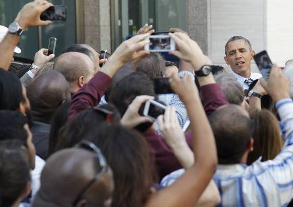 Reuters - El presidente de Estados Unidos Barack Obama saluda a la gente en la calle despu&#233;s de que &#233;l y el vicepresidente Joe Biden compraran el almuerzo en una tienda cerca de la Casa Blanca en Washington.