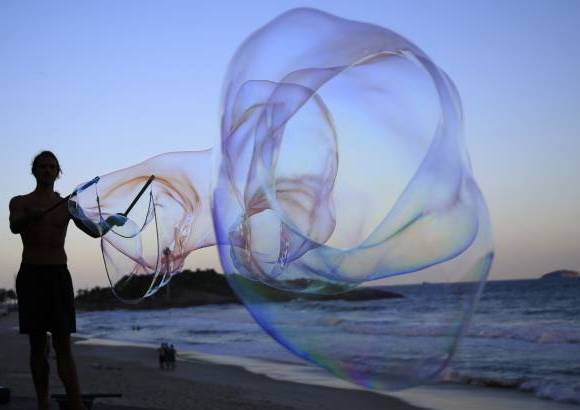 AP - Florian Timm, artista callejero alemán, de 27 años, crea burbujas gigantes de jabón en la playa de Ipanema en Río de Janeiro, Brasil.