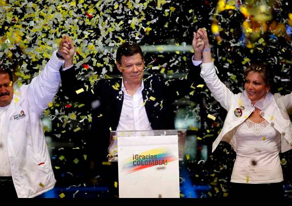 Reuters - Santos en señal de victoria al lado de su vicepresidente Angelino Garzón y próxima primera Dama, María Clemencia.