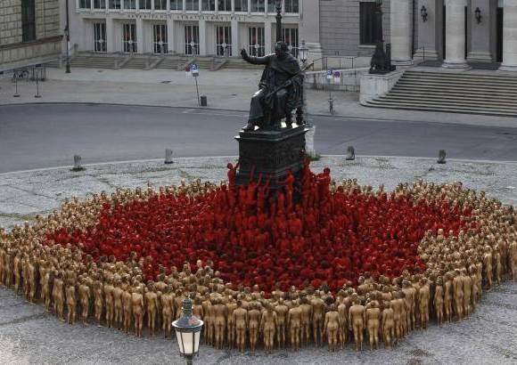 Reuters - Tunick, conocido por sus sesiones en lugares p&#250;blicos con modelos desnudos, pretende reproducir con los participantes, cubiertos &#250;nicamente con pintura corporal de color oro o rojo, motivos de la tetralog&#237;a wagneriana El anillo del Nibelungo.