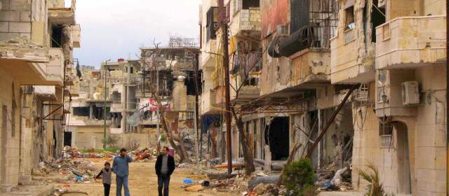 "Cese el fuego" de Siria inició con 30 muertos | Miembros de la oposición caminan por las calles de Homs después de los ataques. FOTO REUTERS