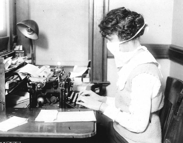 Esta secretaria muestra el tipo de tapabocas, en 1918, que bajaba hasta el cuello. FOTO Getty