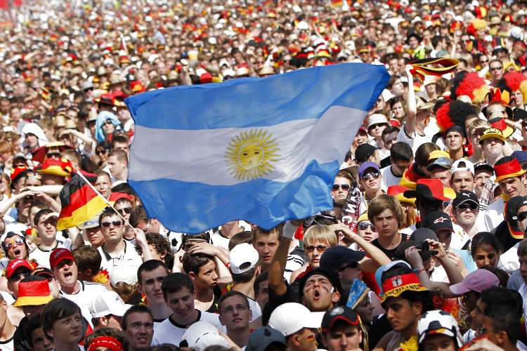 AP - Un único hincha Argentino muestra orgulloso la bandera de su país, en medio de miles de hinchas alemanes que ven el partido entre estos dos seleccionados.