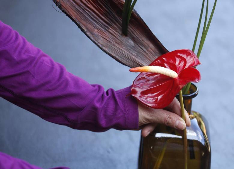 Corte el anturio, que el tallo quede al ras de la botella. Mida la flor al borde de una mesa, para que le quede exacta.