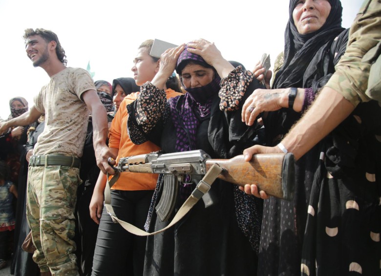 Soldados de Turquía formaron un cordón con sus armas para controlar una multitud de desplazados sirios, que se agolparon para recibir ayudas humanitarias en la frontera de ambos países. FOTO AFP