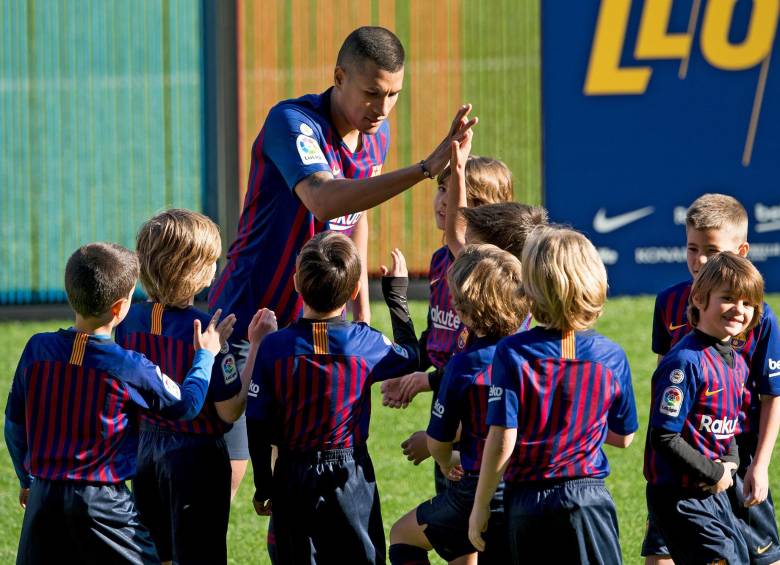 En el césped del Camp Nou, el defensor compartió con niños de las escuelas del cuadro catalán. FOTO AFP