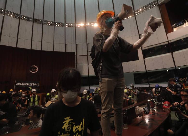 Cientos de manifestantes irrumpen en el Parlamento de Hong Kong (China), este lunes. Tras pasar más de cuatro horas intentando echar abajo la entrada del edificio con barras de acero, ladrillos o piedras, los manifestantes consiguieron acceder al interior pasadas las 21.00 hora local. Foto: AFP