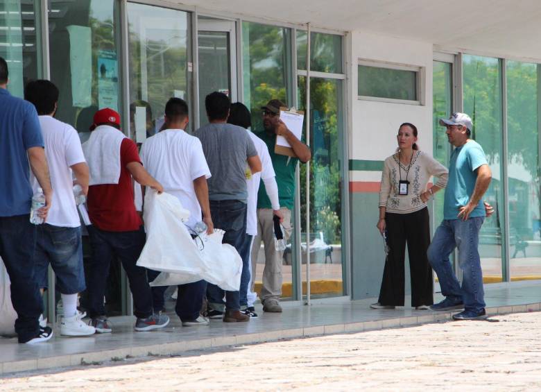 Migrantes deportados colocan sus pertenencias en bolsas blancas por la garita Puente Nuevo, en el paso fronterizo de Matamoros (México). El arribo a diario de un centenar de deportados mexicanos desde Estados Unidos a la ciudad de Matamoros anticipa la posible llegada de más personas Foto: EFE