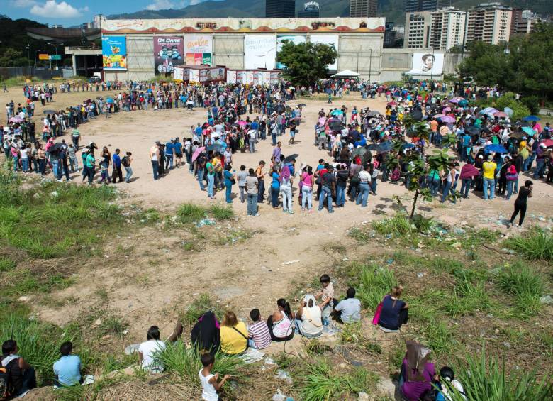 Las personas hacen una larga cola fuera del supermercado Bicentenario, de propiedad estatal, en Caracas, el 16 de enero de 2015. Venezuela sufre la escasez de casi un tercio de todos los productos básicos. FOTO AFP 