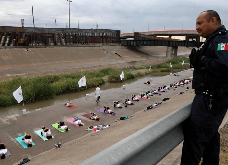 Vecinos de uno y otro lado de la frontera se unieron para practicar yoga con mensaje de paz en el paso de migrantes. Guardas fronterizos de ambas naciones se limitaron a contemplar los ejercicios.